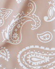 Close-up women's tan/white paisley shorts
