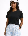 Woman wearing a black top and RF-Wear Women's Paisley Shorts in White/Baby Blue