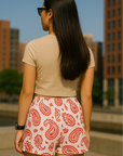 Woman standing in city wearing RF-Wear Women's Paisley Shorts - White/Red - Back View