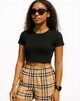 Woman wearing a black top and RF-Wear Women's Tartan Plaid Shorts in Tan/Black