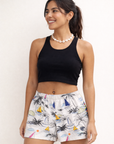Woman wearing a black top and RF-Wear Women's Sailboat Shorts in White/Multicolors