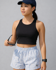 Woman wearing black top and RF-Wear Women's Snakeskin Shorts in Baby Blue