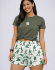 Woman wearing a green top and RF-Wear Women's Soldier Shorts in White/Green