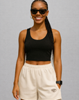 Woman wearing a black crop top and RF-Wear Women's Solid Color Shorts in Cream