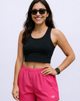 Woman Wearing a black top and RF-Wear Women's Solid Color Shorts in Fuchsia