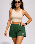 Woman wearing a neutral color crop top with RF-Wear Women's Solid Color Shorts in Green