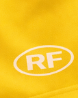 Close-up of RF-Wear Women's Solid Color Shorts in Yellow with RF logo