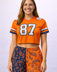 Woman wearing an orange jersey and RF-Wear Women's Split Paisley Shorts in Navy/Orange
