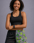 Woman wearing a black top and RF-Wear Women's Split Shamrock Shorts in Black/Green