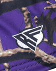 Close-up of a brand logo on a purple tree camo shorts