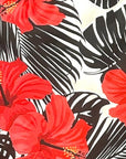 Close-up of RF-Wear Women's Tropical Flower in Coral on Black/White Shorts.