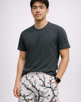 Man wearing a grey t-shirt and RF-Wear Men's Mesh Blossom Shorts in White/Burgundy