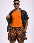 Man wearing an orange tank top and RF-Wear Men's Mesh Lava Shorts in Black/Orange