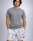 Man wearing a grey t-shirt and RF-Wear Men's Mesh Marble Shorts in Black/White
