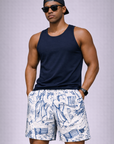 Man wearing a navy tank top and RF-Wear Men's Patriotic Porcelain Shorts in White/Blue