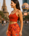 Woman in red athletic outfit with star pattern standing on Vegas Strip.