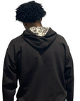 Man wearing RF-Wear Beanie Skull Hoodie in Brown from a back view.