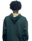Person wearing a forest green RF-Wear beanie skull hoodie hoodie  on a white background back view.