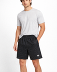 Man wearing a white t-shirt and RF-Wear Men's Animal Print Shorts - Leopard in Black