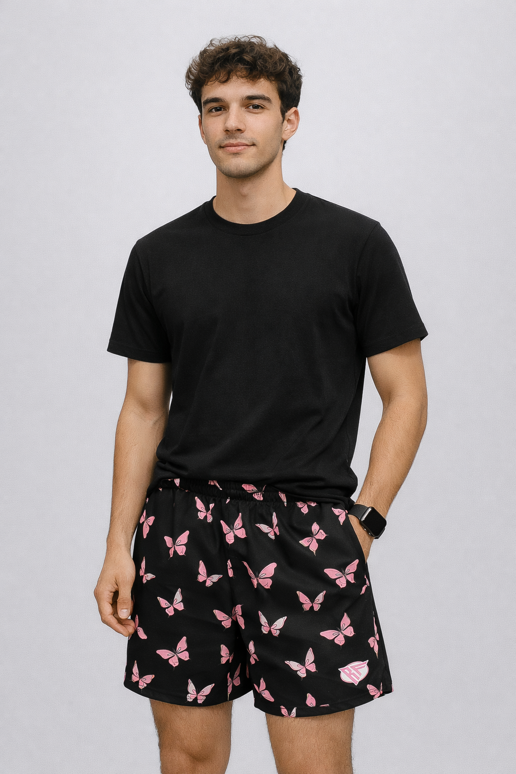 Man wearing a black t-shirt and RF-Wear Men's Butterfly Shorts in Black/Pink