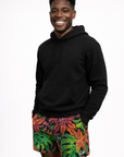 Man wearing a black hoodie and RF-Wear Men's Floral Tropical Vibe Shorts in Multicolors