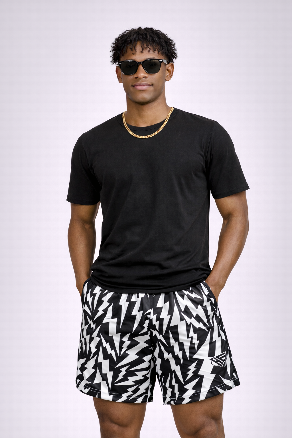 Man wearing a black t-shirt and RF-Wear Men's Lightning Bolt Shorts in Black/White 