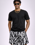 Man wearing a black t-shirt and RF-Wear Men's Lightning Bolt Shorts in Black/White 