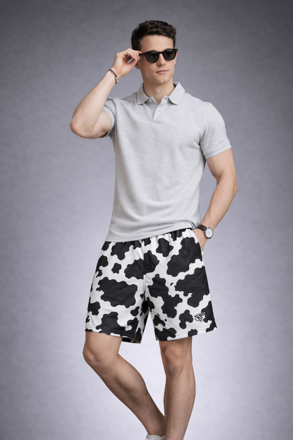 Man wearing a polo top and RF-Wear Men's Mesh Animal Print Shorts  - Cow - Black/White