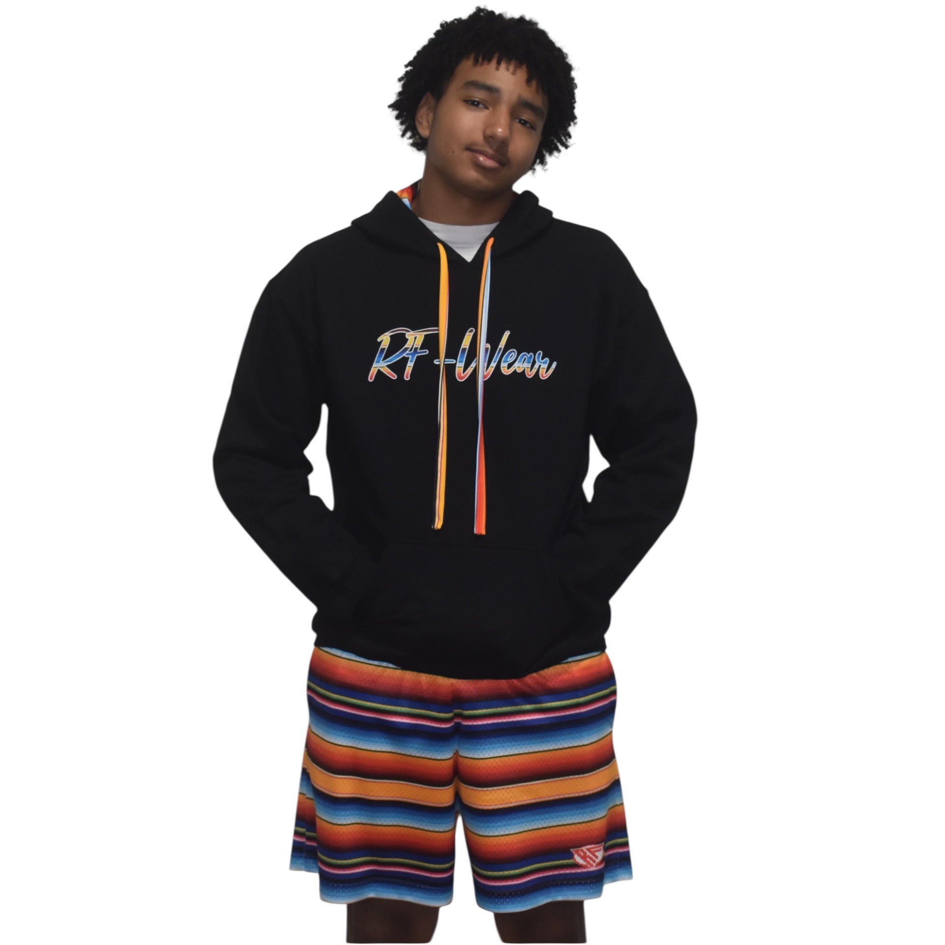 Person wearing a black Baja hoodie with colorful drawstrings and Baja striped shorts on a white background