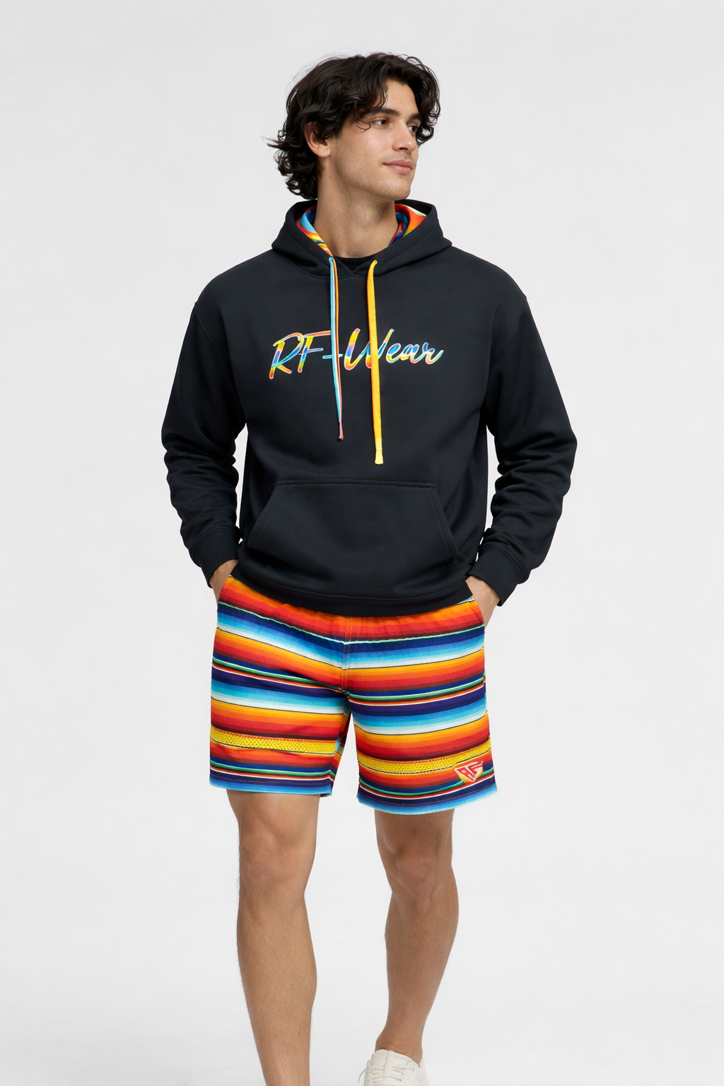 Man wearing a black hoodie and Men's RF-Wear Mesh Baja Shorts - Multicolor