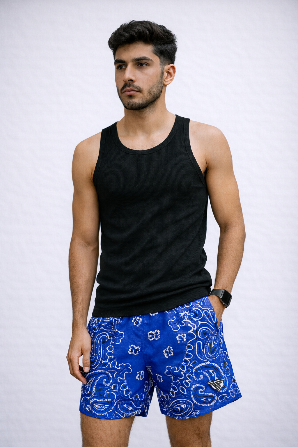 Man wearing a black tank top and RF-Wear Men's Mesh Bandana Shorts in blue. 
