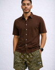 Man wearing a brown shirt and RF-Wear Men's Mesh Bandana Shorts in Brown