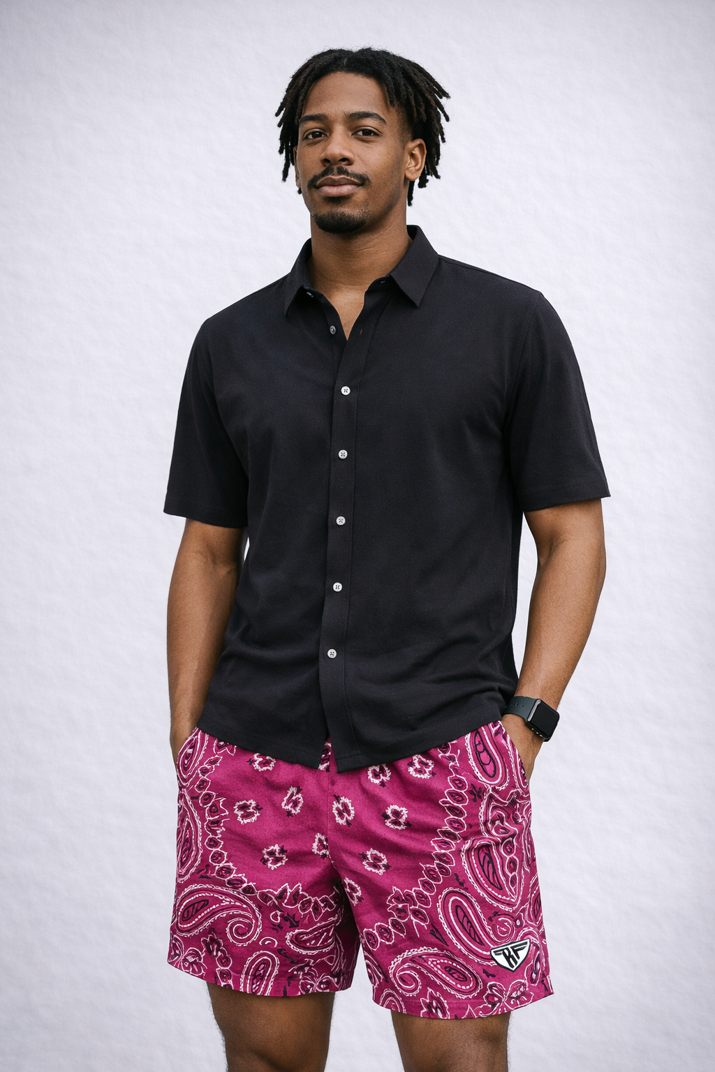 Man wearing a black shirt and RF-Wear Men's Mesh Bandana Shorts in Fuchsia/White