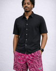 Man wearing a black shirt and RF-Wear Men's Mesh Bandana Shorts in Fuchsia/White