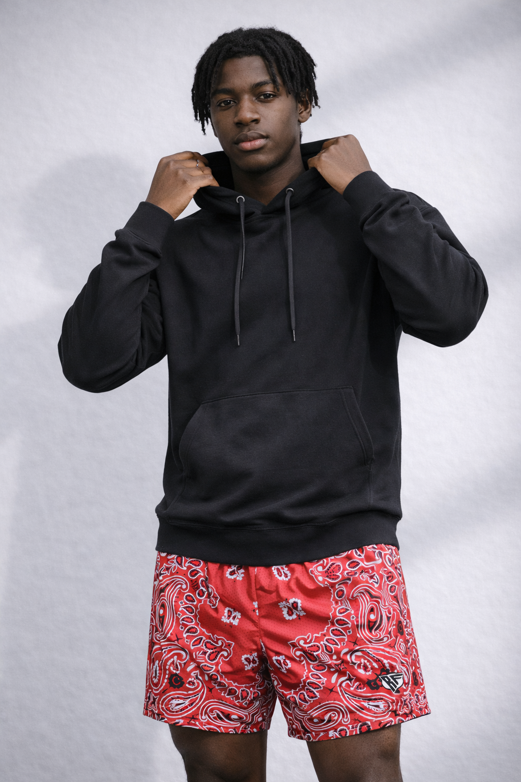 Man wearing a black hoodie and RF-Wear Men's Mesh Bandana Shorts in Red 
