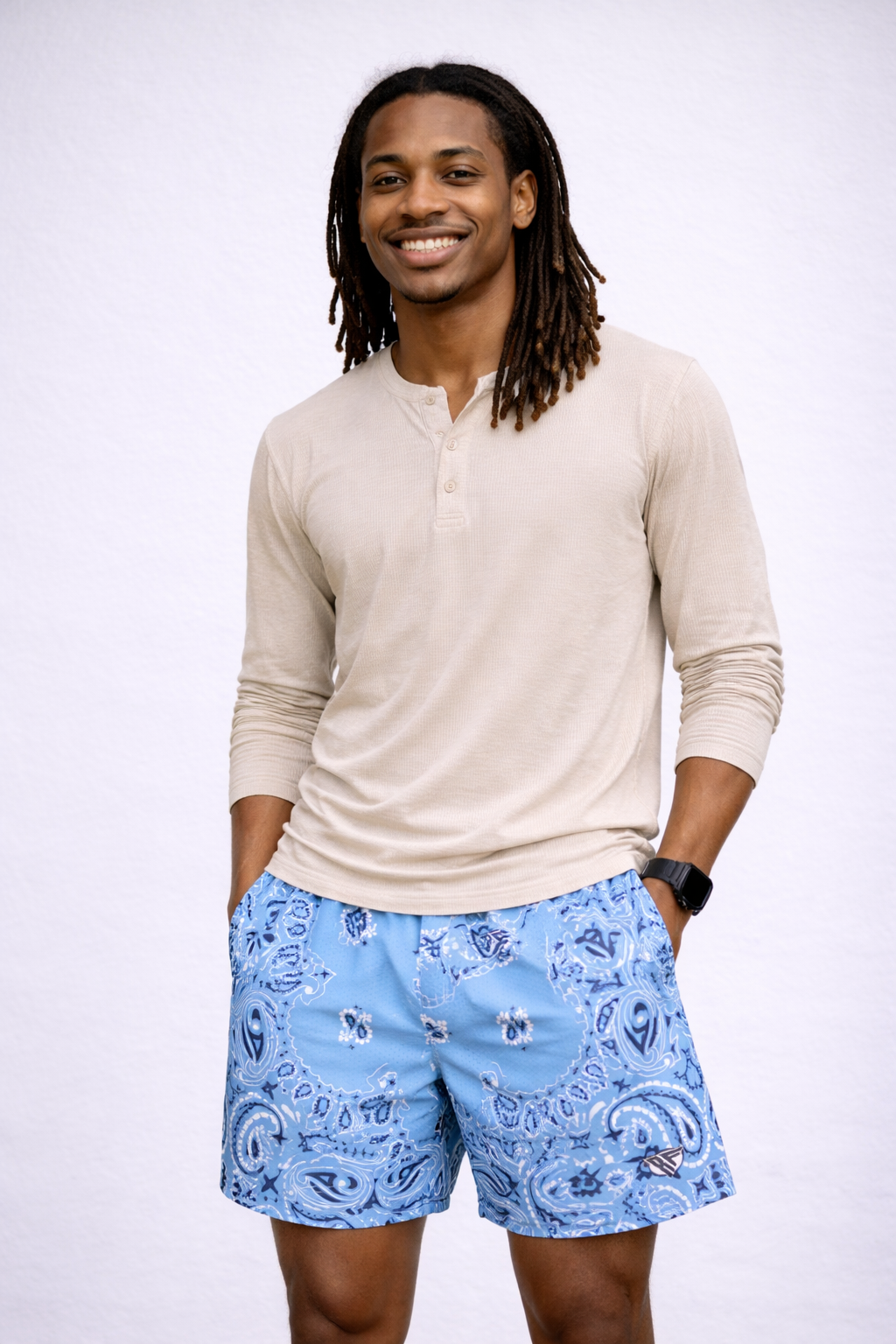 Man wearing a natural colored shirt and RF-Wear Men's Mesh Bandana Shorts in Sky Blue 