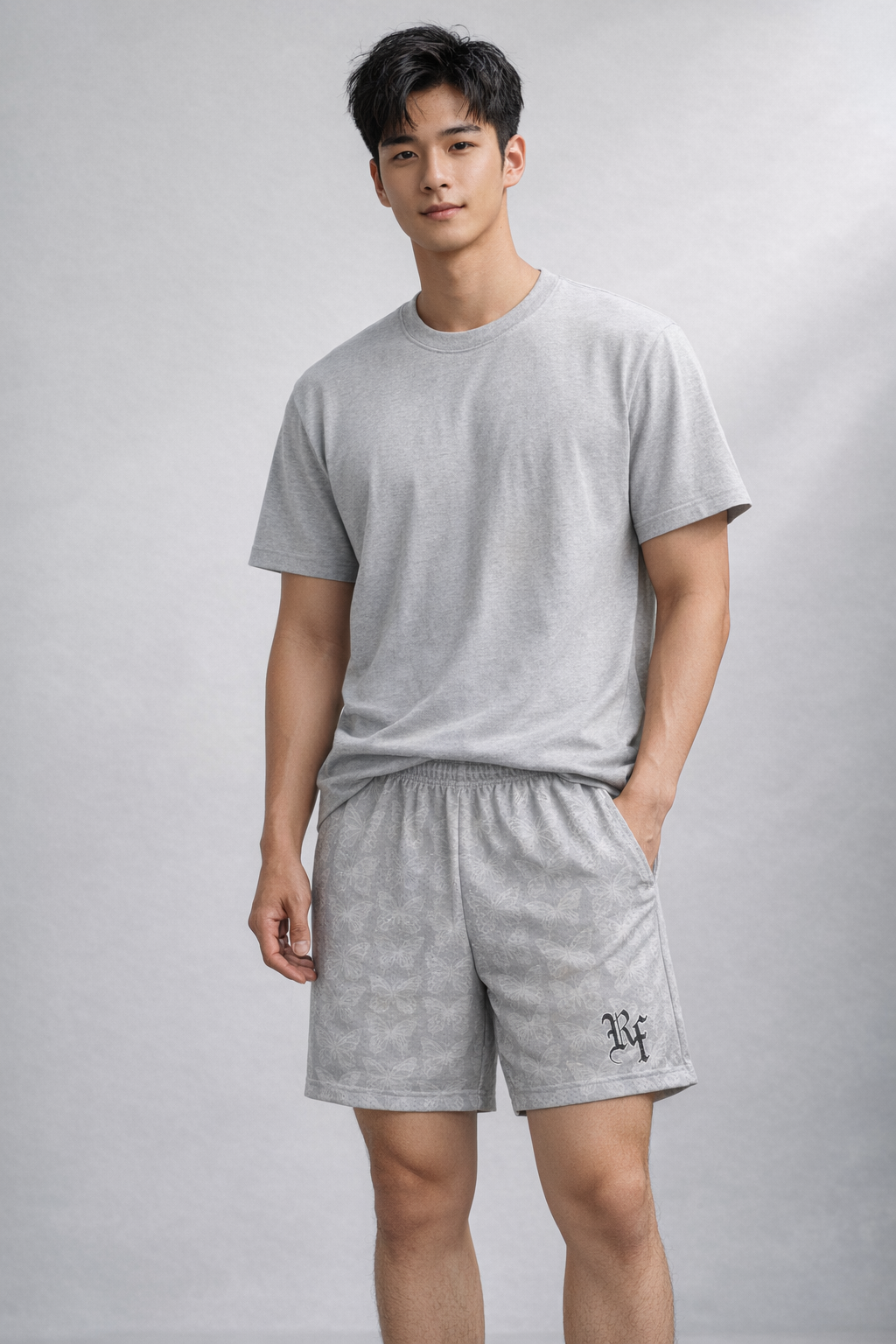 Man wearing a grey t-shirt and RF-Wear Men's Mesh Butterfly Shorts in Grey 