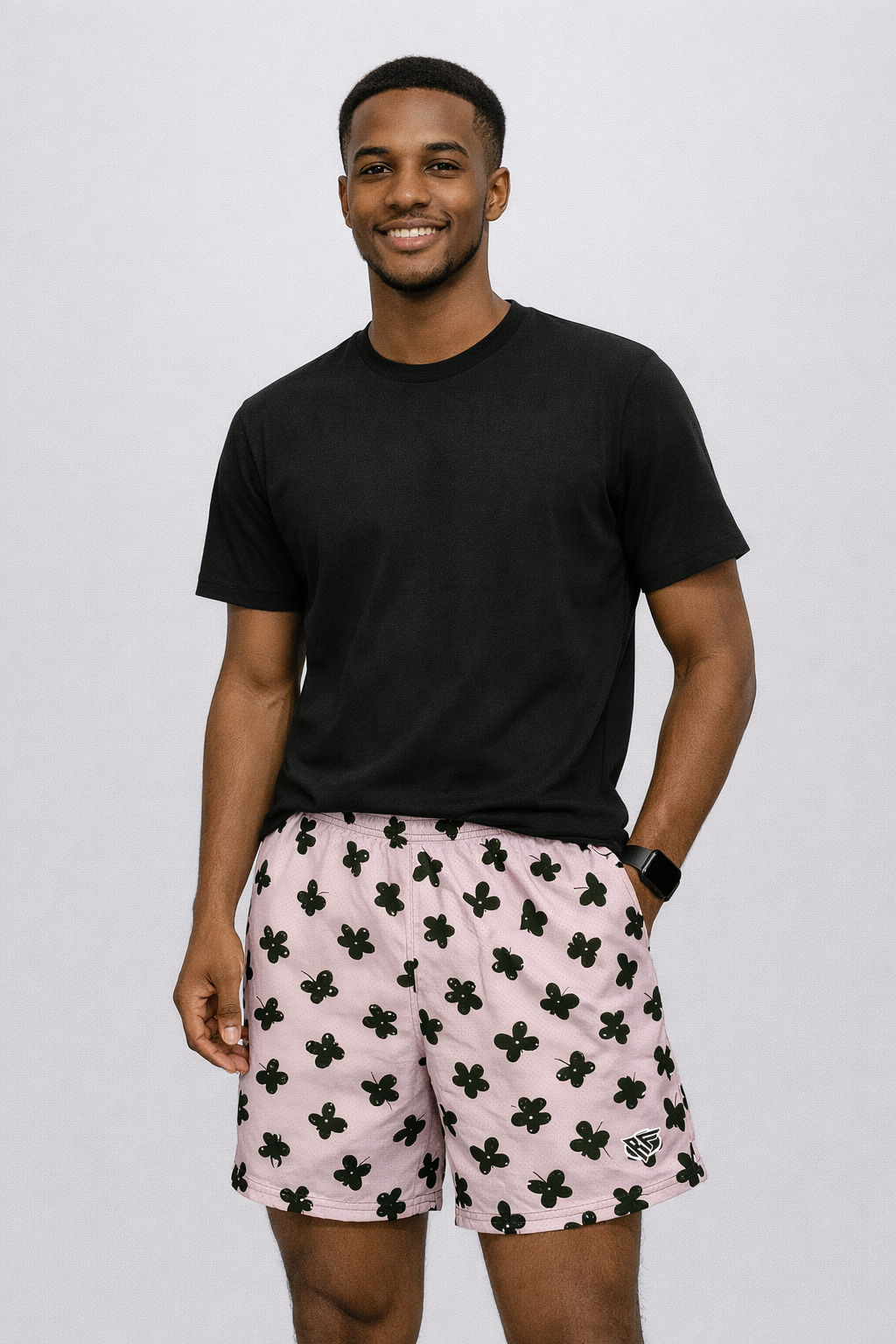 Man wearing a black t-shirt and RF-Wear Men's Mesh Butterfly Shorts in Lilac/Black 