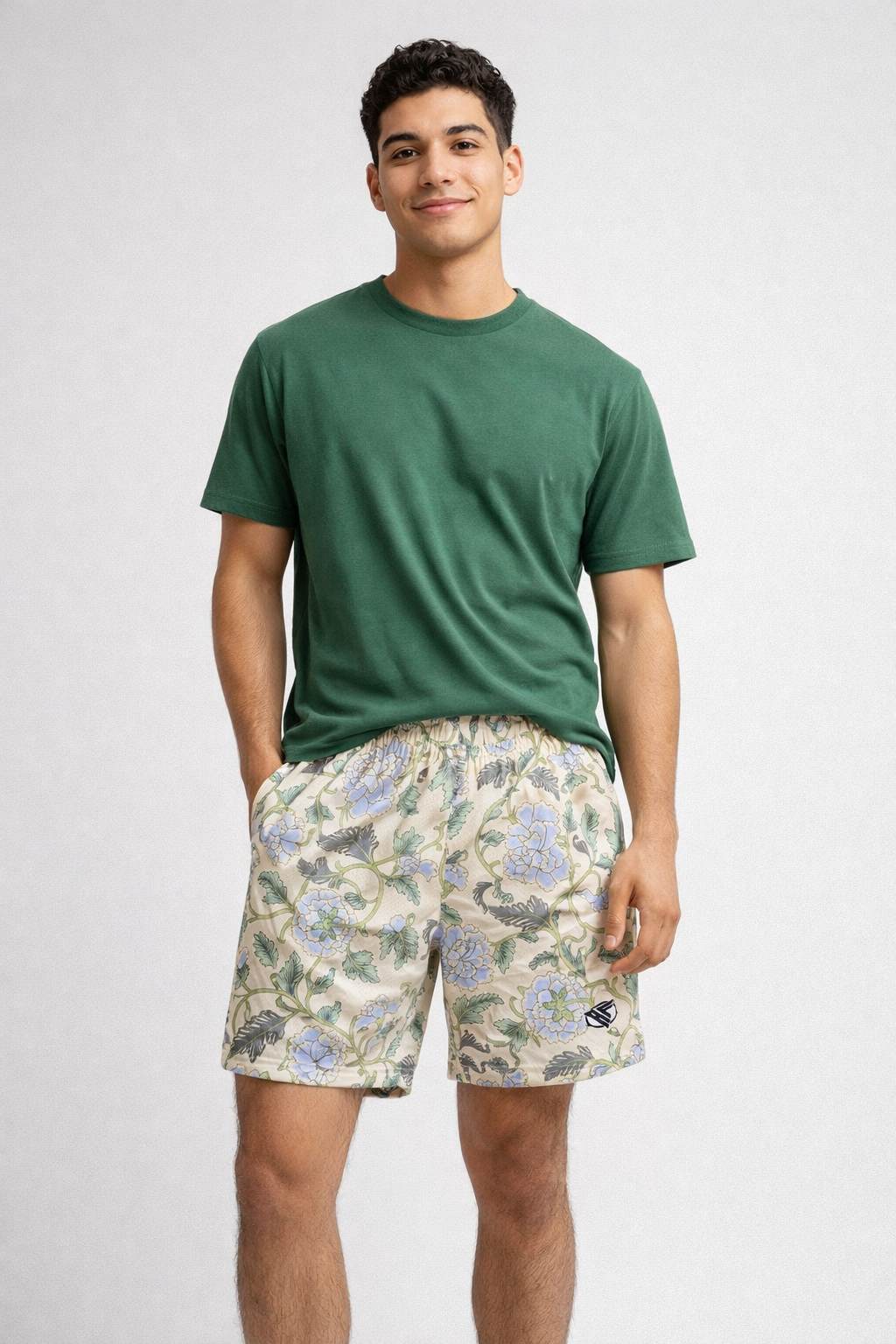Man wearing a green t-shirt and RF-Wear Men's Mesh Carnation Shorts in Cream/Blue