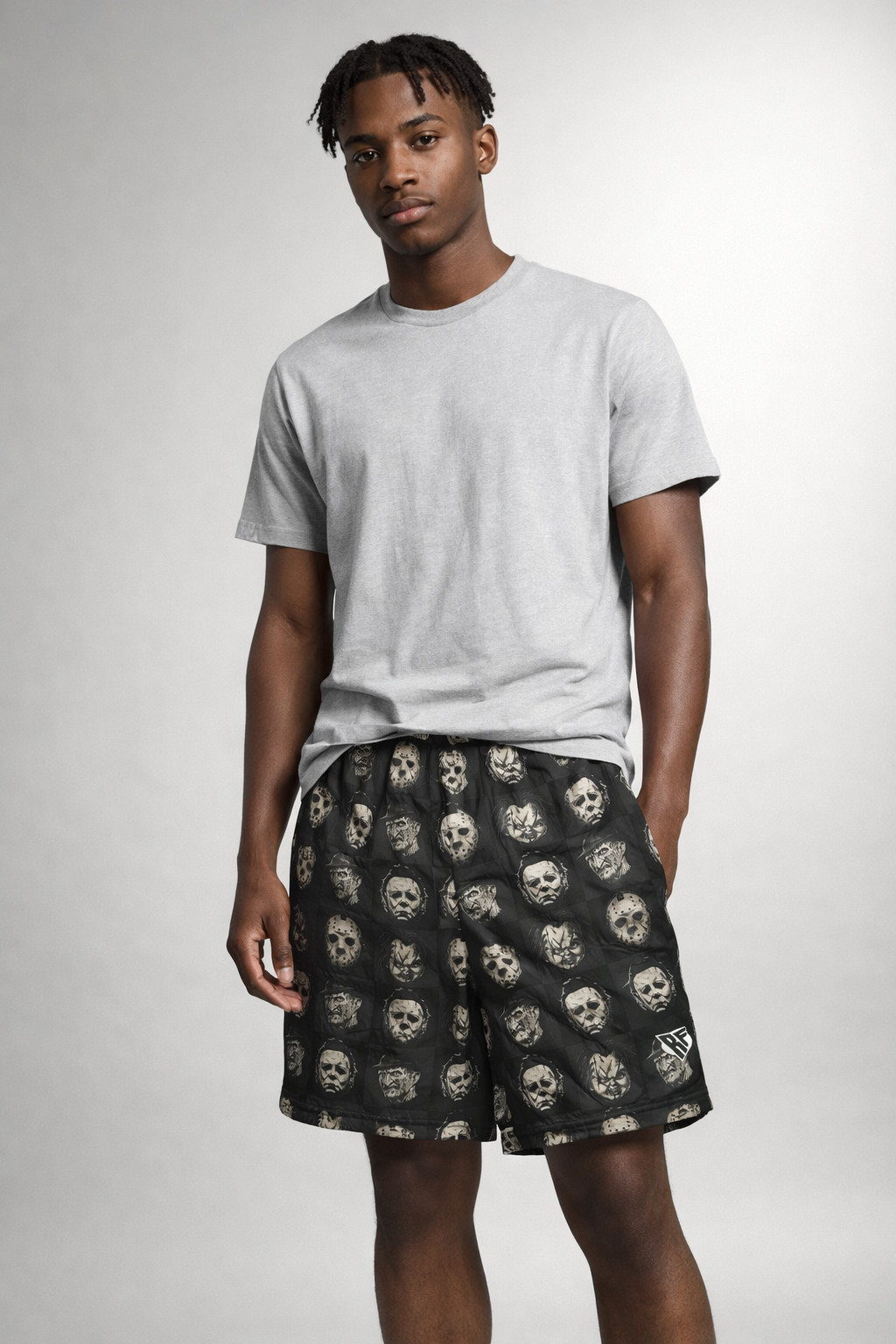 Man wearing a t-shirt and RF-Wear Men's Mesh Checkered Horror Shorts in Black 