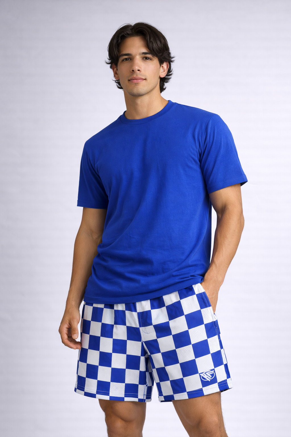 Man wearing a blue t-shirt and RF-Wear Men's Mesh Checkered Shorts in Blue/White 