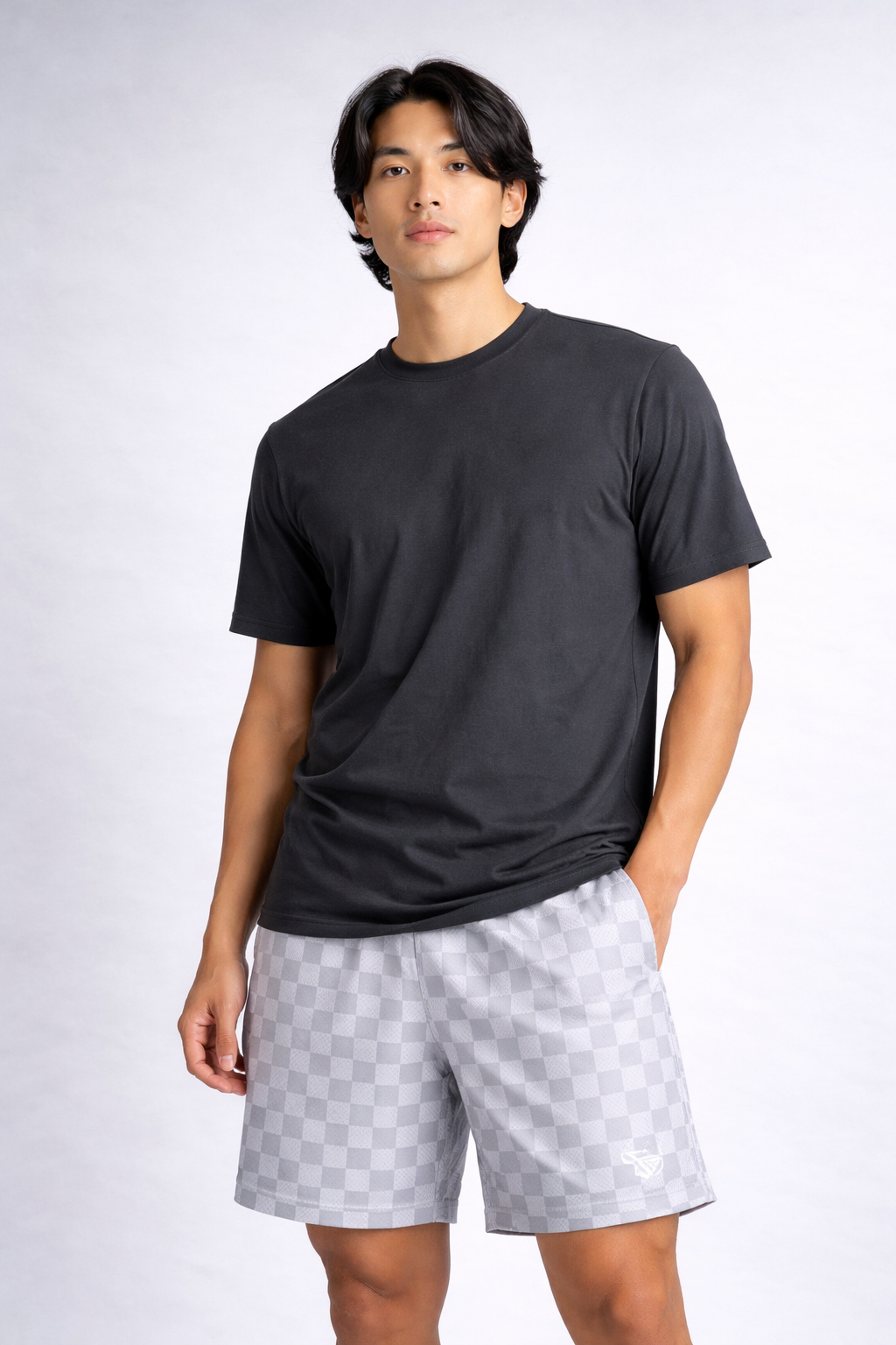 Man wearing a dark grey t-shirt and RF-Wear Men's Mesh Checkered Shorts in Grey