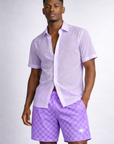 Man wearing a sheer light lilac dress shirt and RF-Wear Men's Mesh Checkered Shorts in Purple