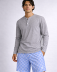 Man wearing a long sleeve grey shirt and RF-Wear Men's Mesh Checkered Shorts in Sky Blue 