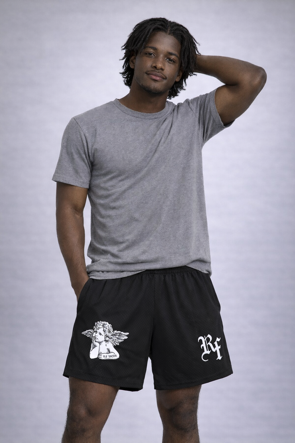 Man wearing a grey t-shirt and RF-Wear Men's Mesh Cherub Shorts in Black