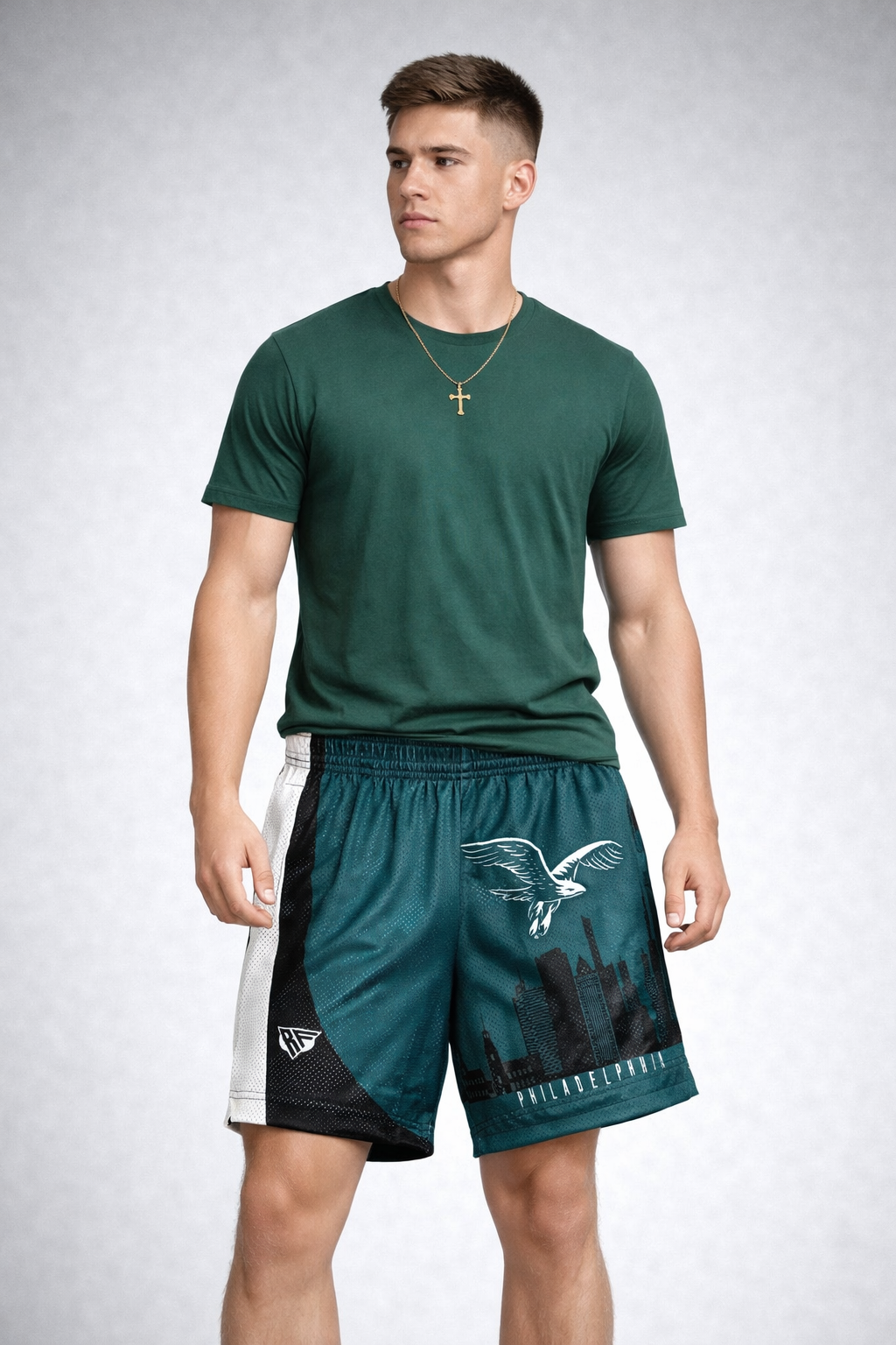 Man wearing a green t-shirt and RF-Wear Men's Mesh Philadelphia Cityscape Shorts in Green/Black