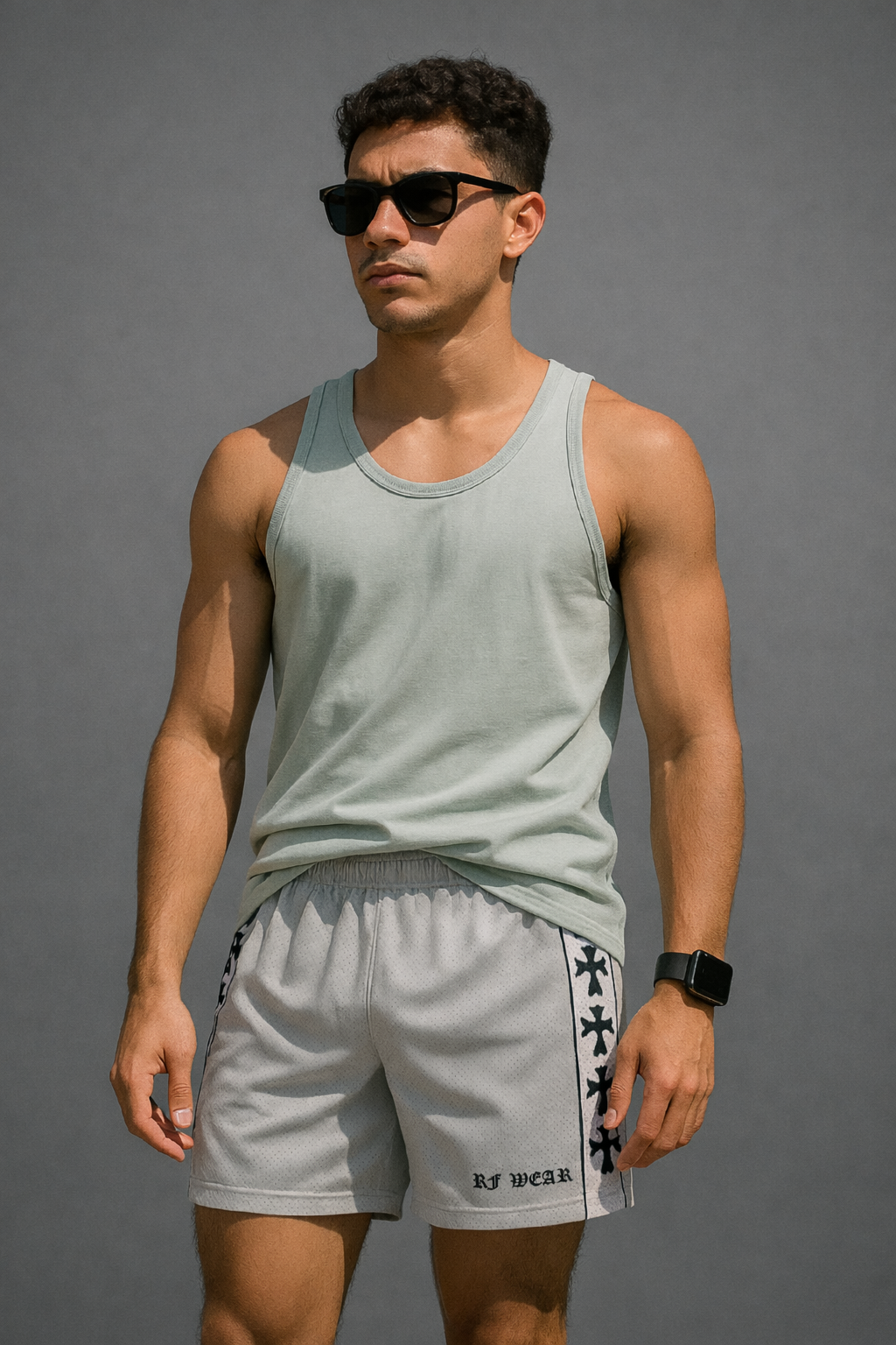 Man wearing RF-Wear Men's Mesh Cross Trim Shorts in Grey with Black Crosses Trim.