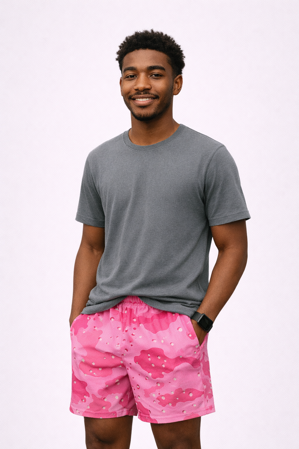 Man wearing a grey t-shirt and RF-Wear Men's Mesh Desert Camo Shorts in Pink