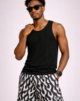Man wearing a black tank top and RF-Wear Men's Mesh Flame Shorts in White/Black 