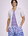 Man wearing a lilac tank shirt with  short sleeve unbuttoned dress shirt and RF-Wear Men's Mesh Flame Shorts in White/Purple 